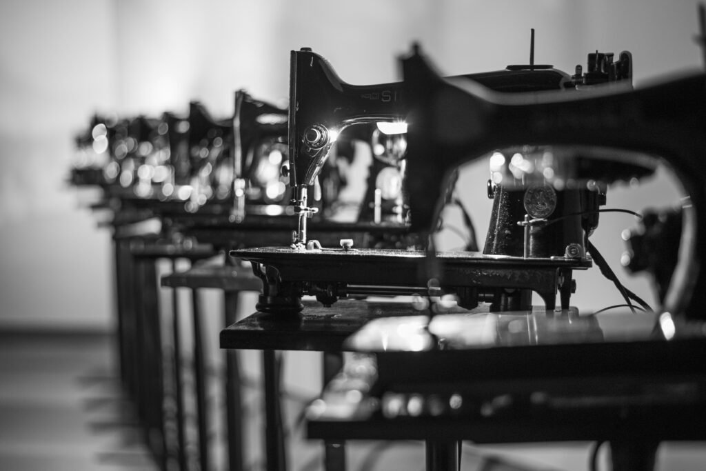 Industrial sewing machines in a garment production workshop